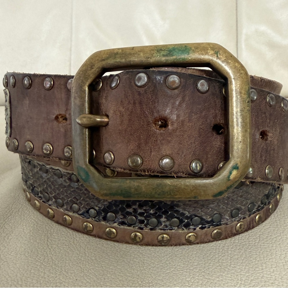 Vintage brown leather belt featuring decorative